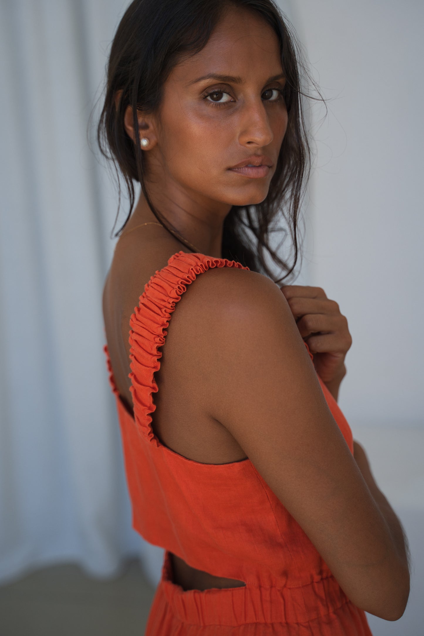 Close-up of the shoulder straps of the Keely Linen jumpsuit in Spritz Orange - Lilly Pilly Collection