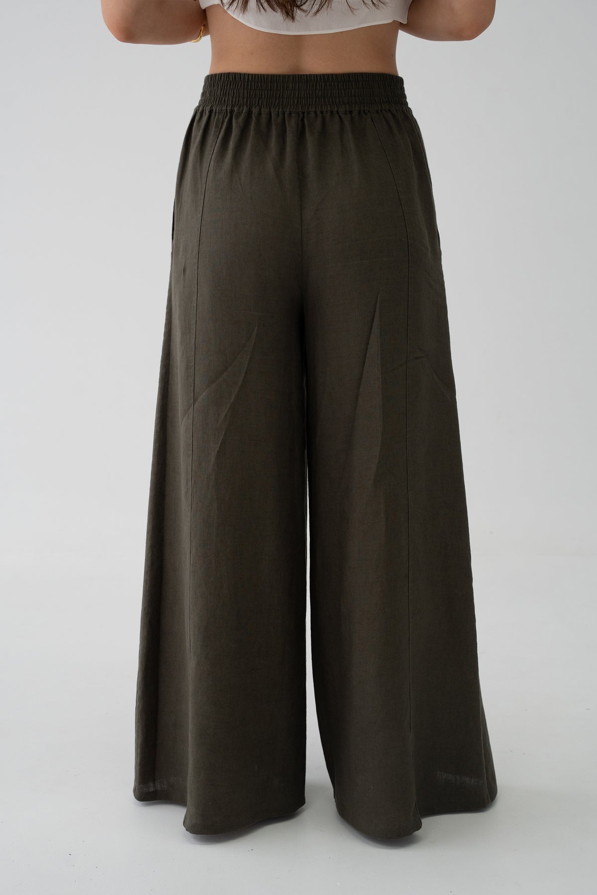 Letty Linen Pants in Khaki - back view close-up of elasticated waistband and wide-leg linen silhouette, studio setting - Lilly Pilly Collection