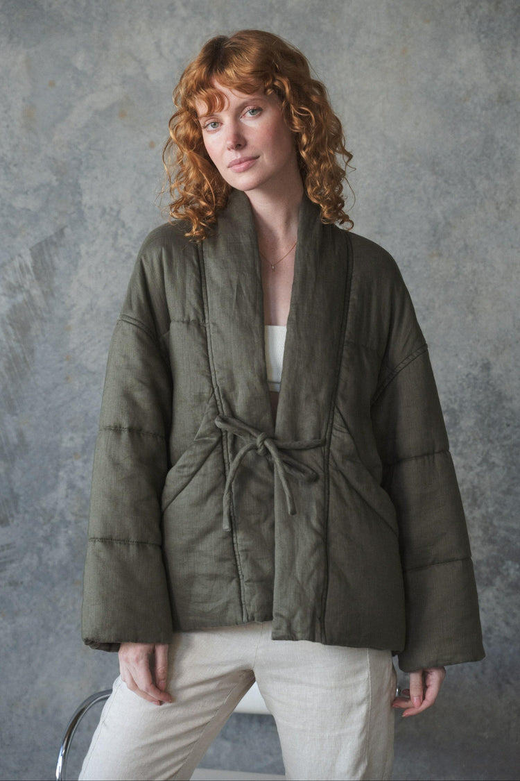 Aster Linen Coat in Khaki - front view, shawl collar and tie-front detail, worn over cream trousers, studio setting - Lilly Pilly Collection