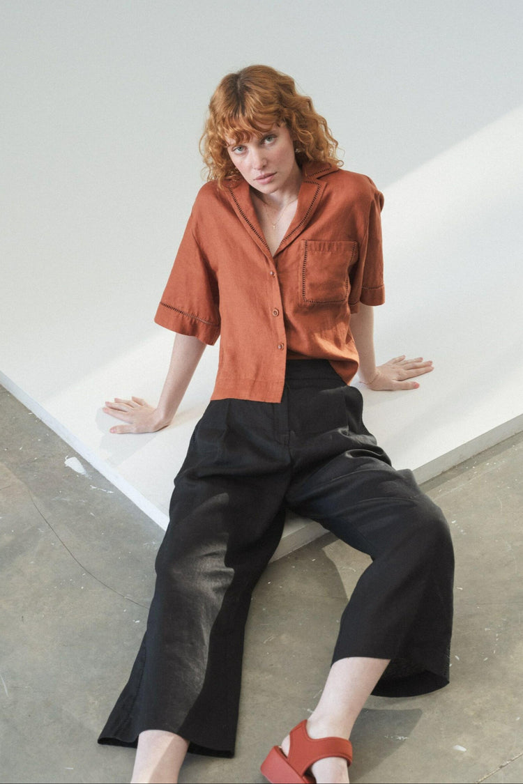 Rika Linen Pants in Black - close up front view while seated - Lilly Pilly Collection