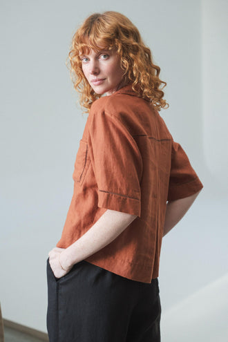Quinn Linen Shirt in Cajun Red - three quarter view paired with black Rika pants - Lilly Pilly Collection