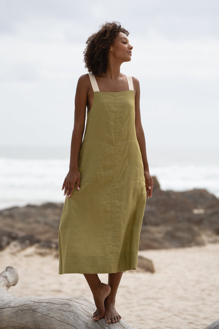 Remi Linen Dress in Olive - full front view staning on a log - Lilly Pilly Collection