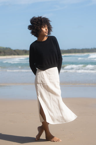 Miri Cashmere Knit in Black - front view while standing on the beach - Lilly Pilly Collection