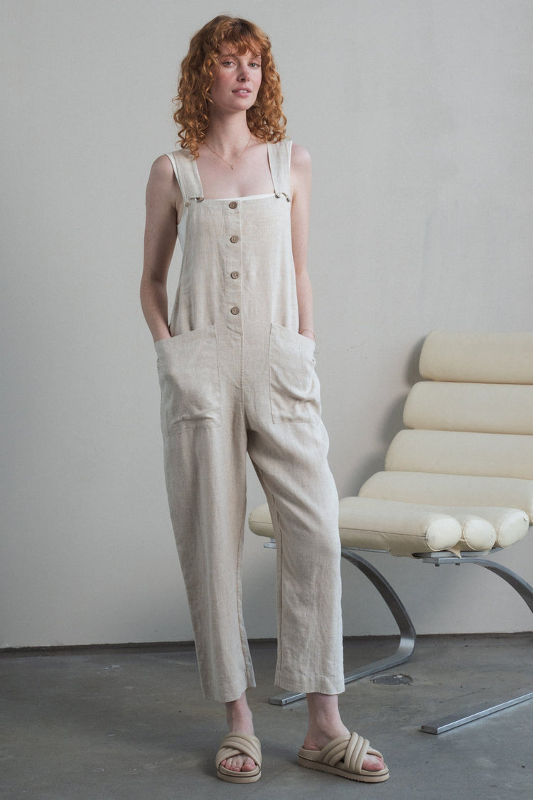 Piper Linen Jumpsuit in Oatmeal - front view with hands on pockets - Lilly Pilly Collection