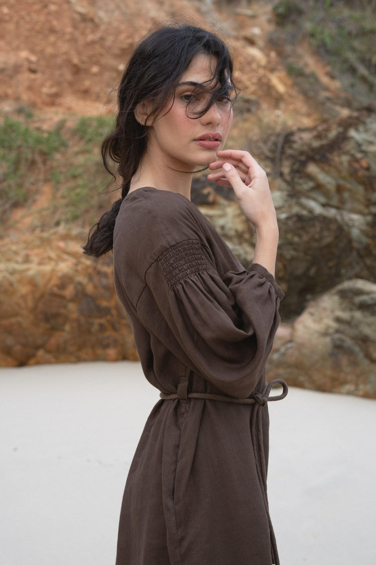 Skylar Linen Dress in Chocolate - side view while on the beach - Lilly Pilly Collection