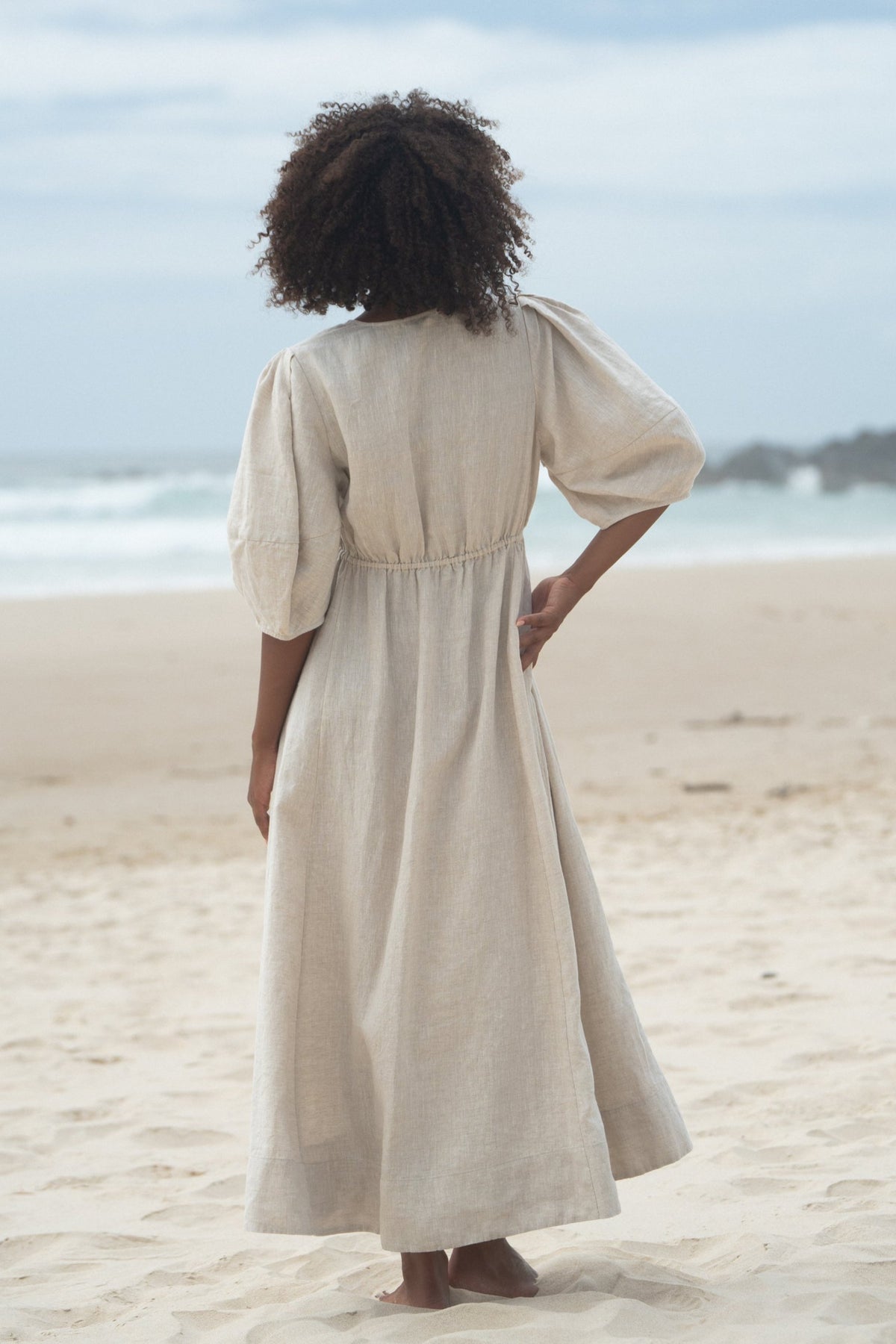 Full back view of a woman wearing the Vida Linen maxi sleeve dress in Oatmeal - Lilly Pilly Collection