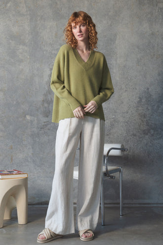 June Cashmere Knit in Olive - front view, hands clasped, worn with Oli Linen Pants in Ivory, studio setting - Lilly Pilly Collection
