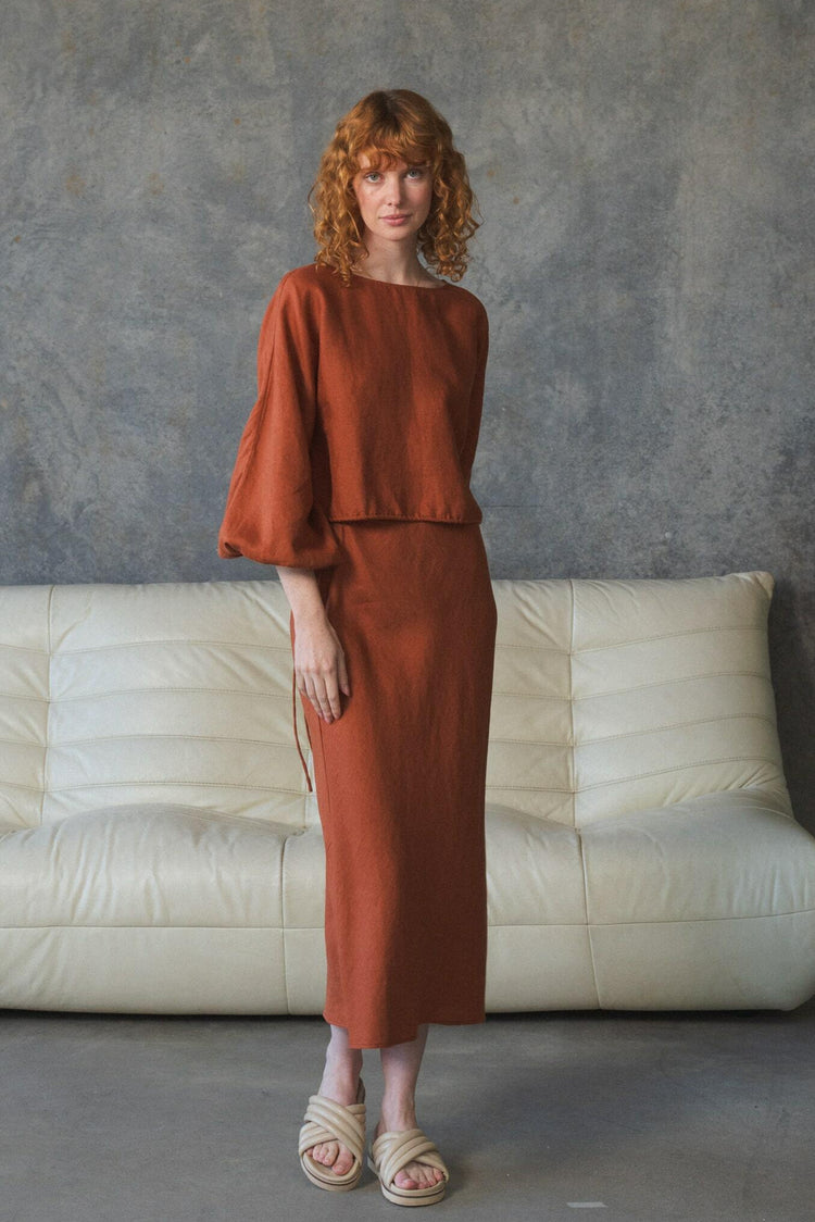 Louisa Linen Top in Cajun Red - full length front view, boat neckline and balloon sleeves, worn with matching tie-waist skirt, studio setting - Lilly Pilly Collection