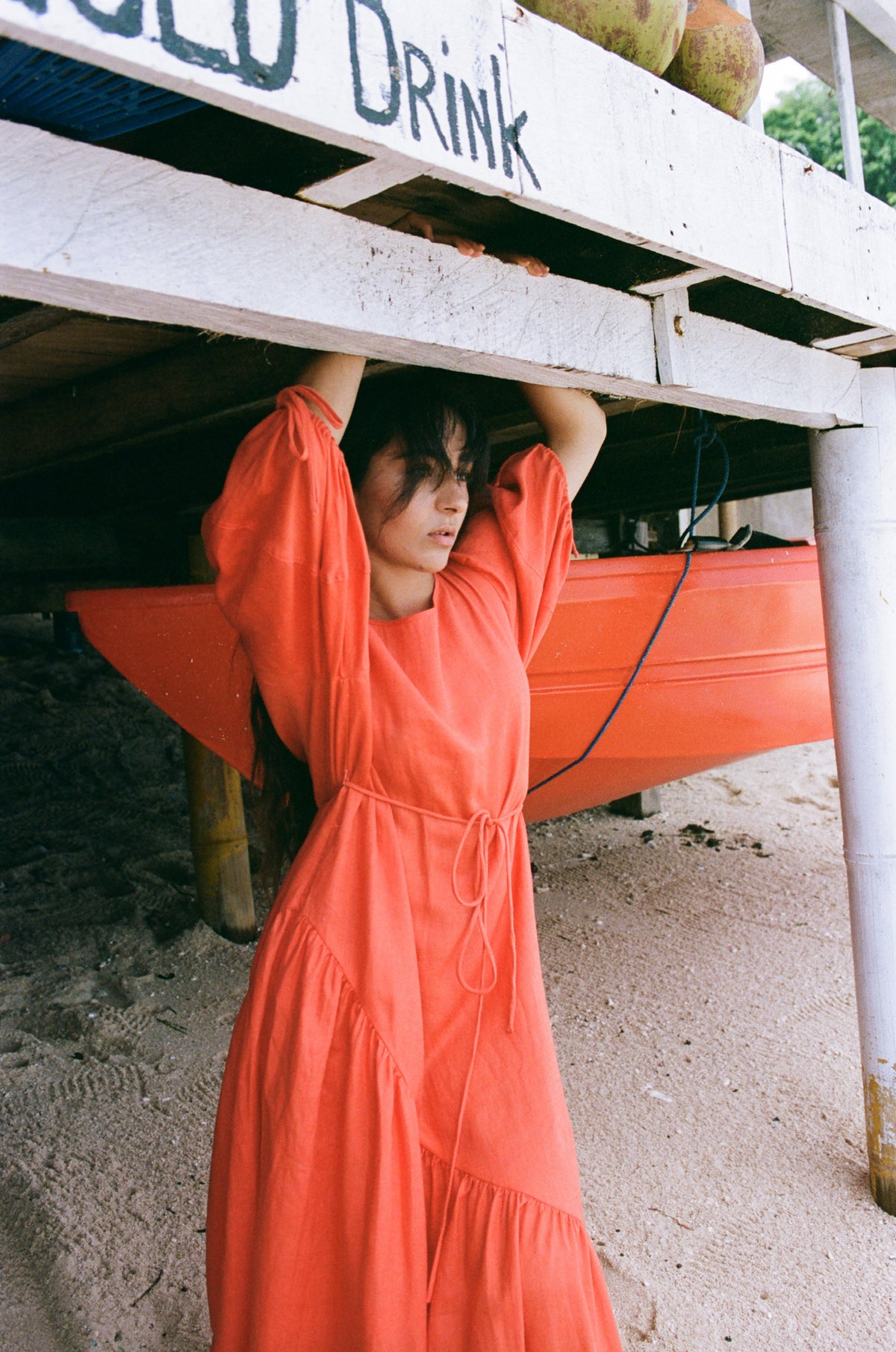 Charlotte Linen Maxi Dress in Spritz Orange - three quarter side view standing on the sand - Lilly Pilly Collection