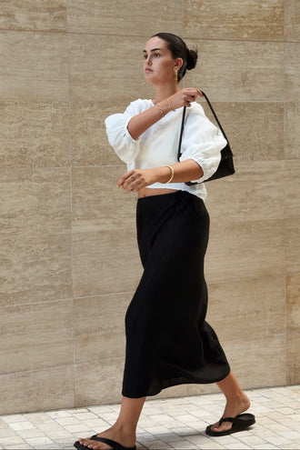 Demi Linen Top in Ivory - woman outdoors, puff sleeves and cropped hem, styled with ivory linen midi skirt - Lilly Pilly Collection