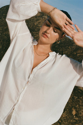 Ember Cotton Voile Shirt in Ivory - close up front view by a rock wall - Lilly Pilly Collection