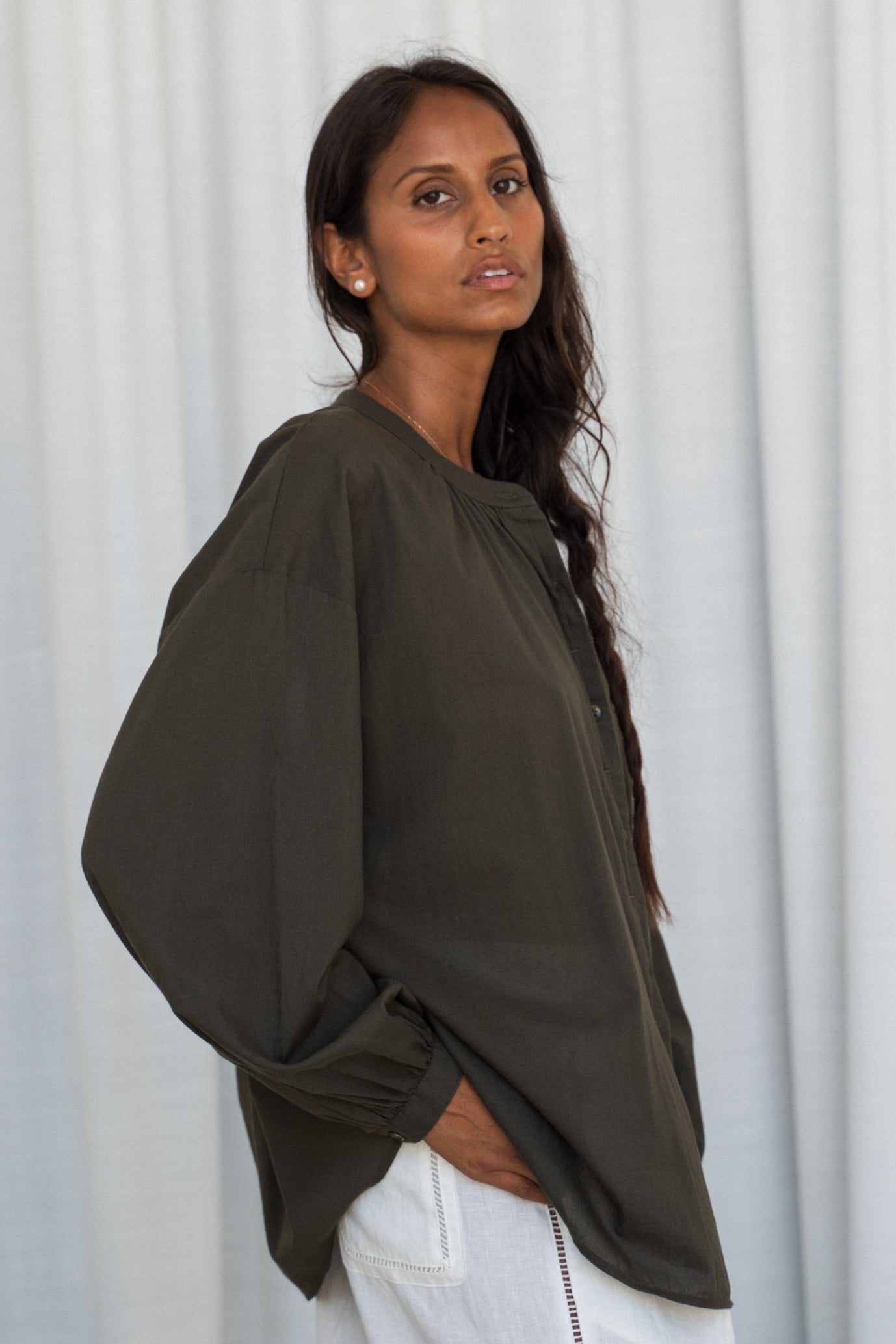 LILLY PILLY woman wearing a khaki Ember cotton voile shirt against a neutral background