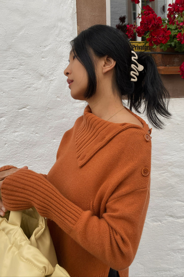 Kaida Cashmere Knit in Cajun Red - side view showing neckline details standing by a white wall - Lilly Pilly Collection 