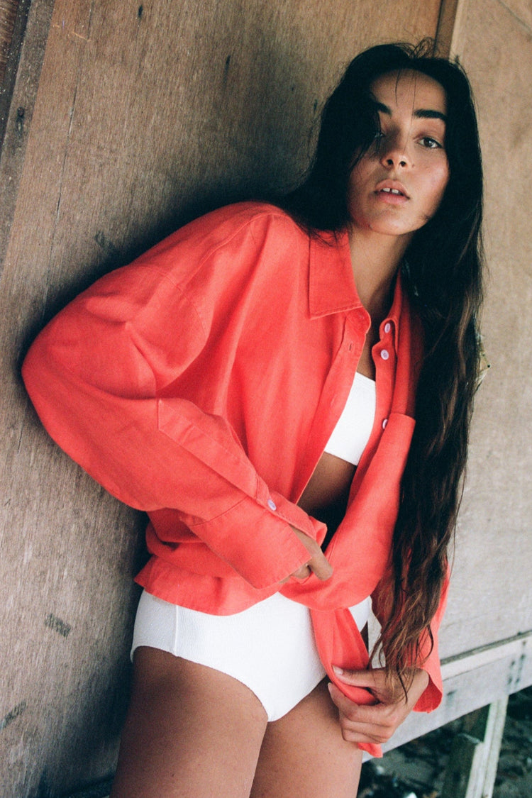 Kirra Linen Shirt in Spritz Orange - front view, leaning against a wall - Lilly Pilly Collection