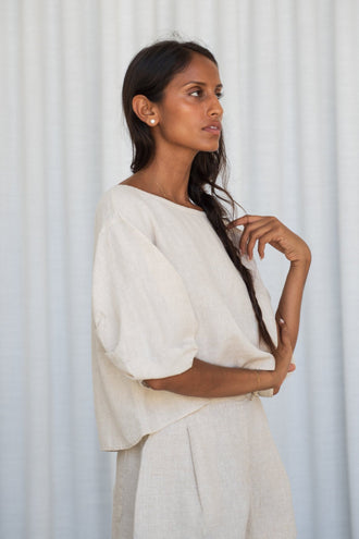 Leia Linen Top in Oatmeal - side profile, arms crossed, worn with Gaia Linen Shorts in Oatmeal, studio setting - Lilly Pilly Collection