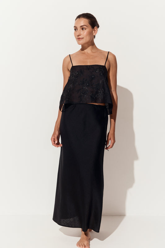 Riley Bias Linen Skirt in Black - front view, straight ankle-length silhouette, styled with a beaded cami, white studio backdrop - Lilly Pilly Collection