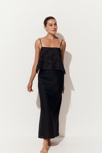 Riley Bias Linen Skirt in Black - front view walking, styled with a beaded cami, white studio backdrop - Lilly Pilly Collection