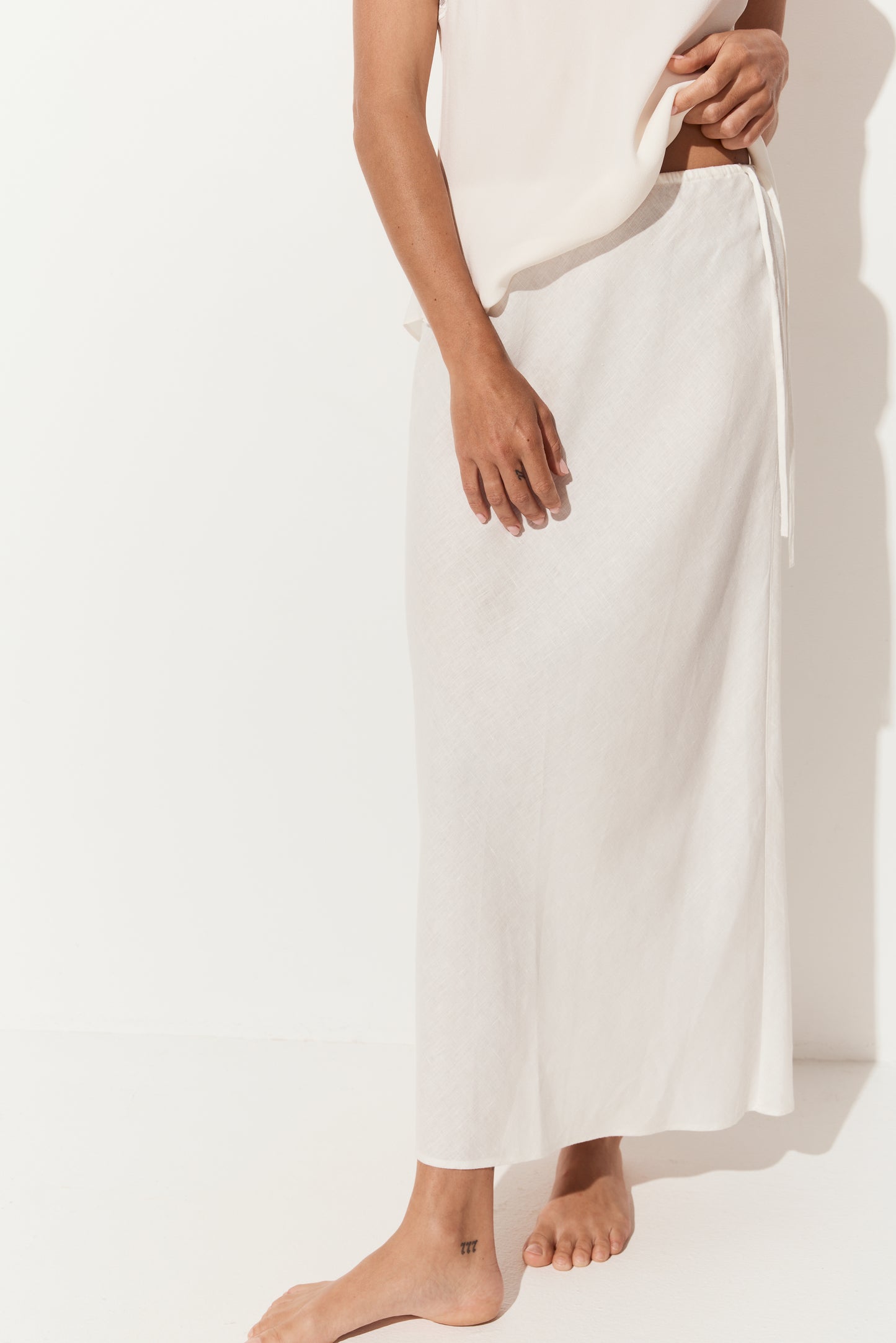 Riley Bias Linen Midi Skirt in Ivory - close up view, bias-cut midi length - Lilly Pilly Collection