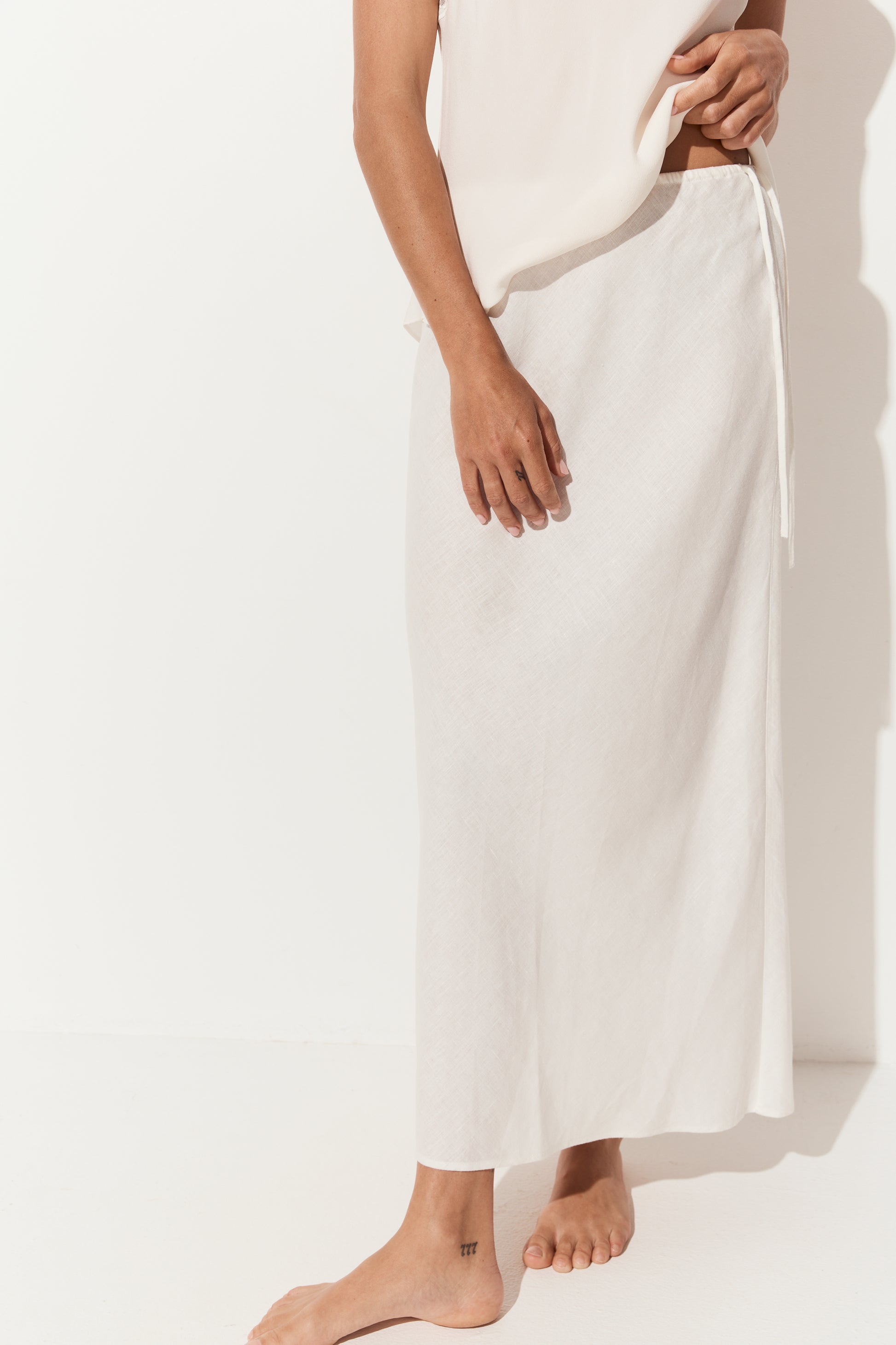 Riley Bias Linen Midi Skirt in Ivory - close up view, bias-cut midi length - Lilly Pilly Collection