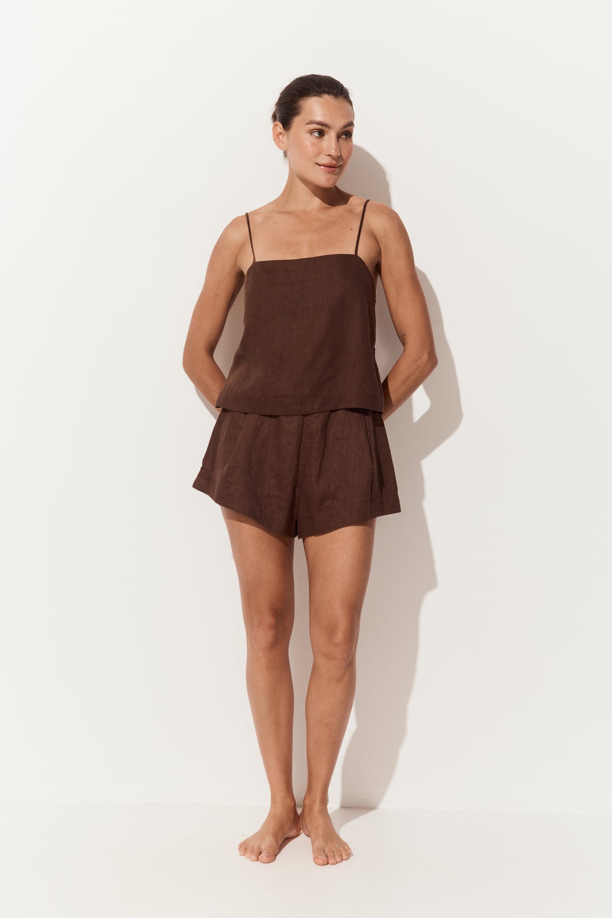 Rosa Linen Cami in Chocolate - front view arms behind back with matching chocolate Gaia linen shorts - Lilly Pilly Collection