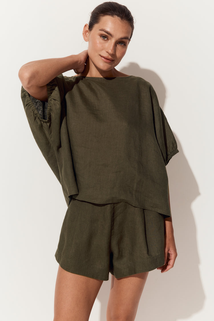 Tina Linen Top in Khaki - front view with arm raised to neck showing batwing sleeves with elasticated cuffs - Lilly Pilly Collection