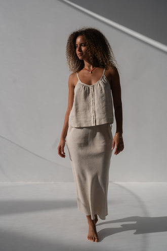 Riley Bias Linen Midi Skirt in Oatmeal - full length, walking, bias-cut midi length, styled with Lola Linen Cami in Oatmeal, white studio - Lilly Pilly Collection