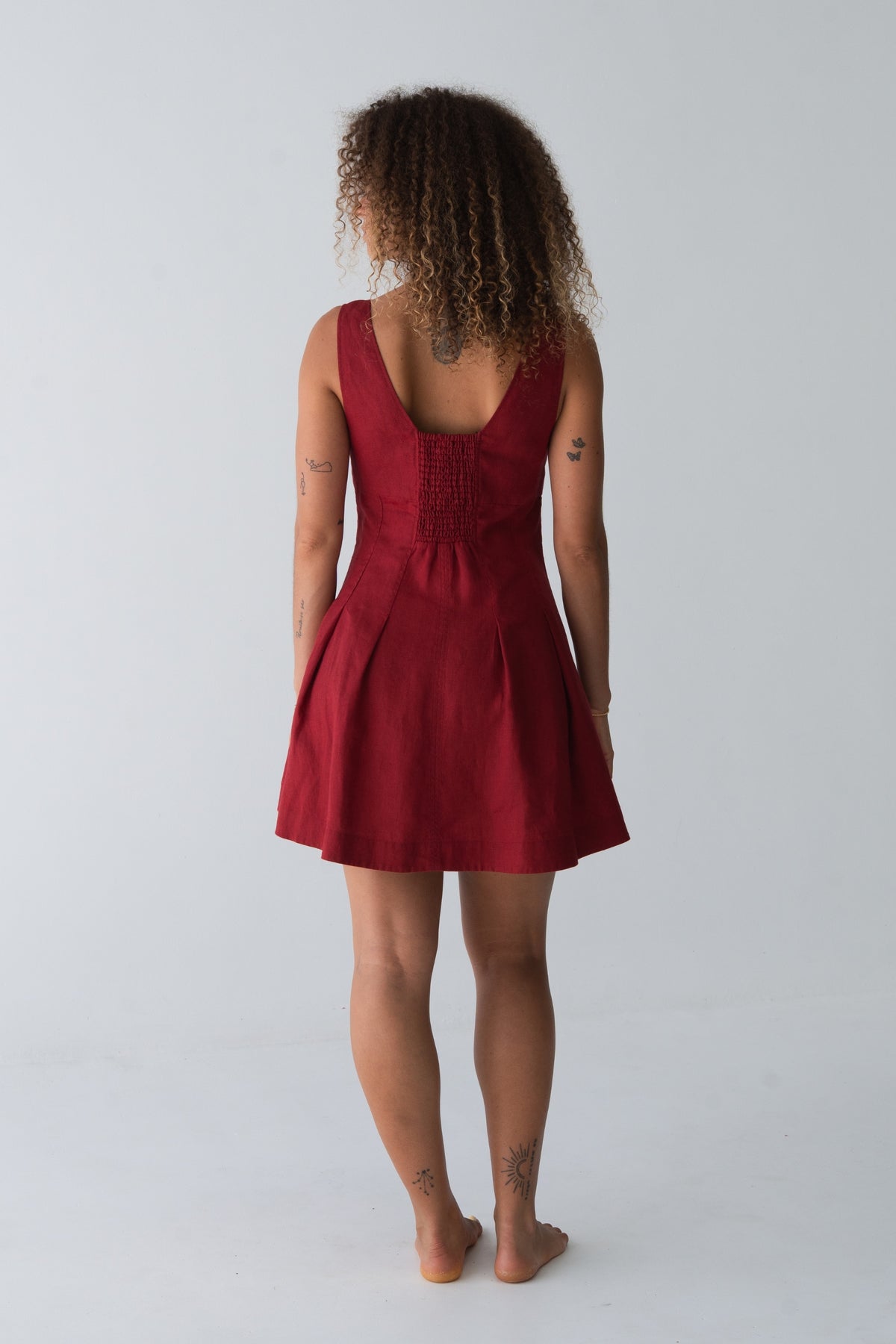 Adele Linen Short Dress in Cherry Red - back view, open back and pleated skirt - Lilly Pilly Collection