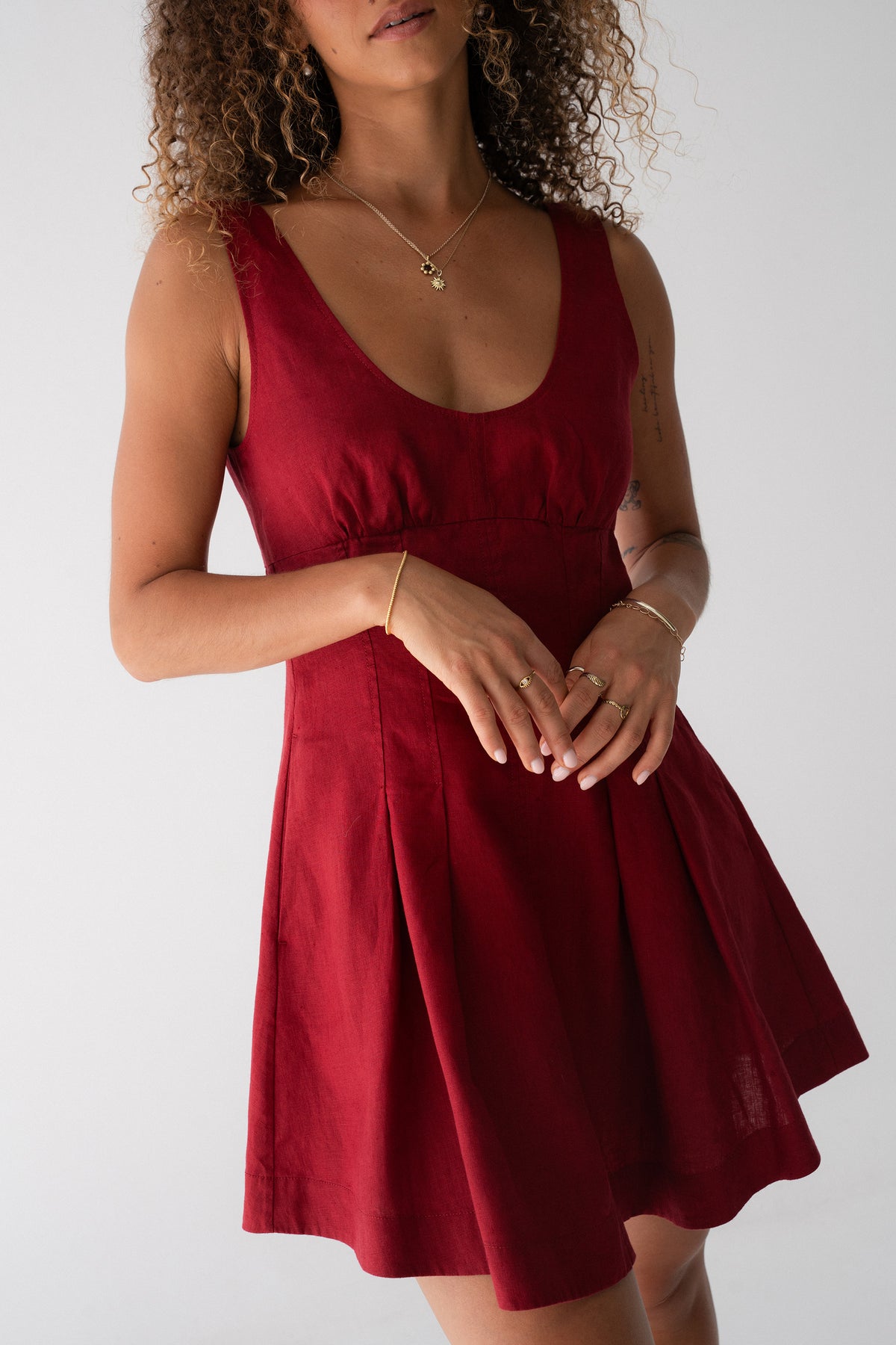 Adele Linen Short Dress in Cherry Red - close-up of scoop neckline and fitted bodice, pleated skirt detail - Lilly Pilly Collection