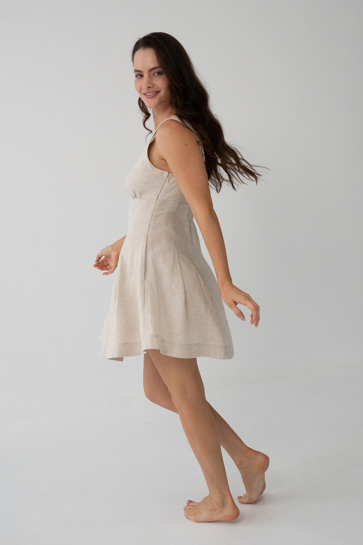 Adele Linen Short Dress in Oatmeal - side profile, scoop neckline and pleated A-line dress in motion - Lilly Pilly Collection