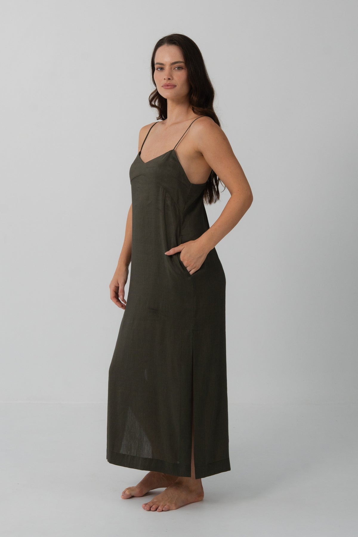 Ally Linen Silk Midi Slip Dress in Khaki - three-quarter view, hand in pocket, V-neckline and side split - Lilly Pilly Collection