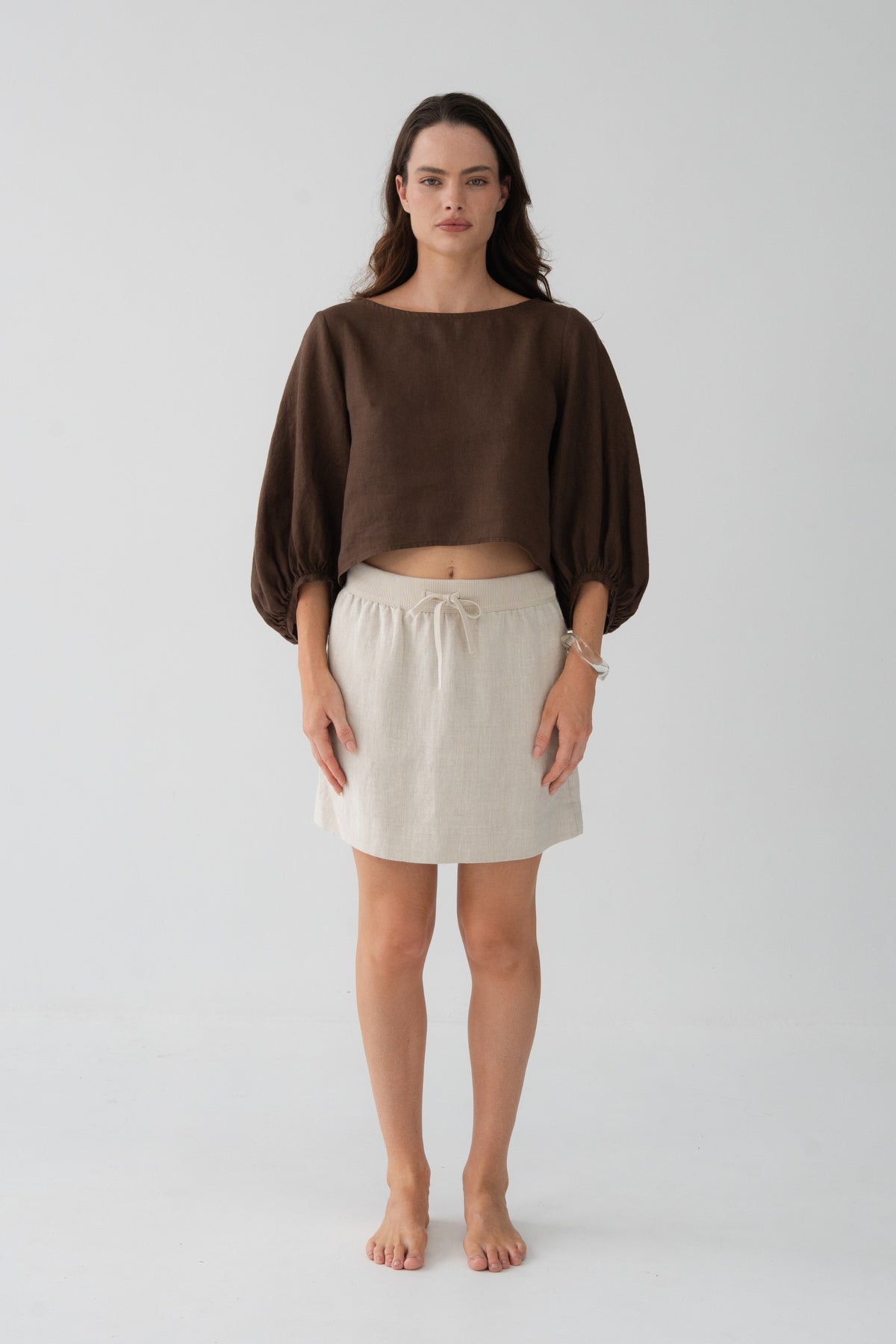 Anelle Linen Mini Skirt in Oatmeal - full length front view, drawstring waistband, worn with Tilly Cotton Voile Shirt in Chocolate - Lilly Pilly Collection