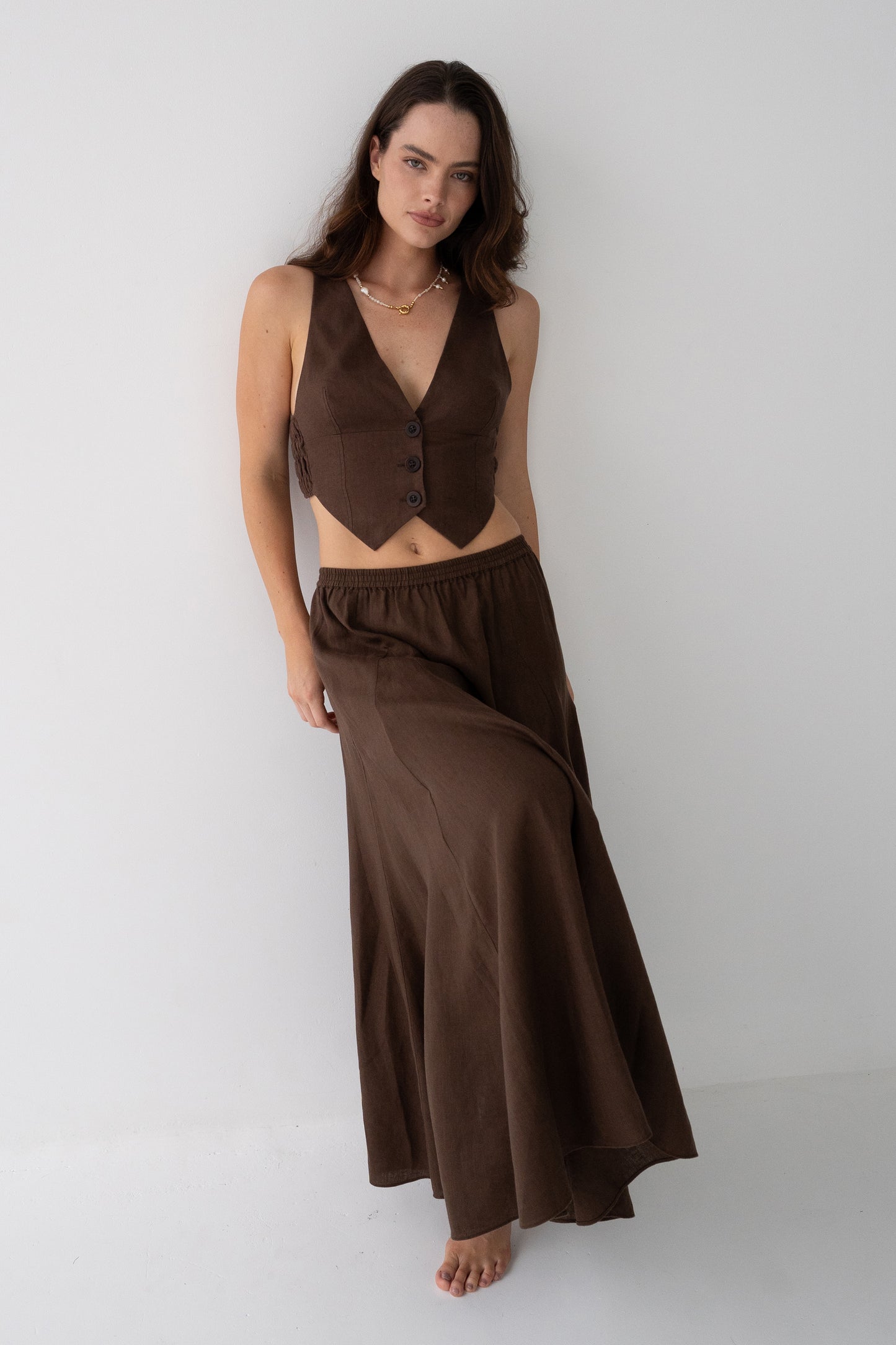 Ari Linen Vest in Chocolate - front three-quarter view, V-neckline and button-front, styled with matching Riley Linen Skirt - Lilly Pilly Collection