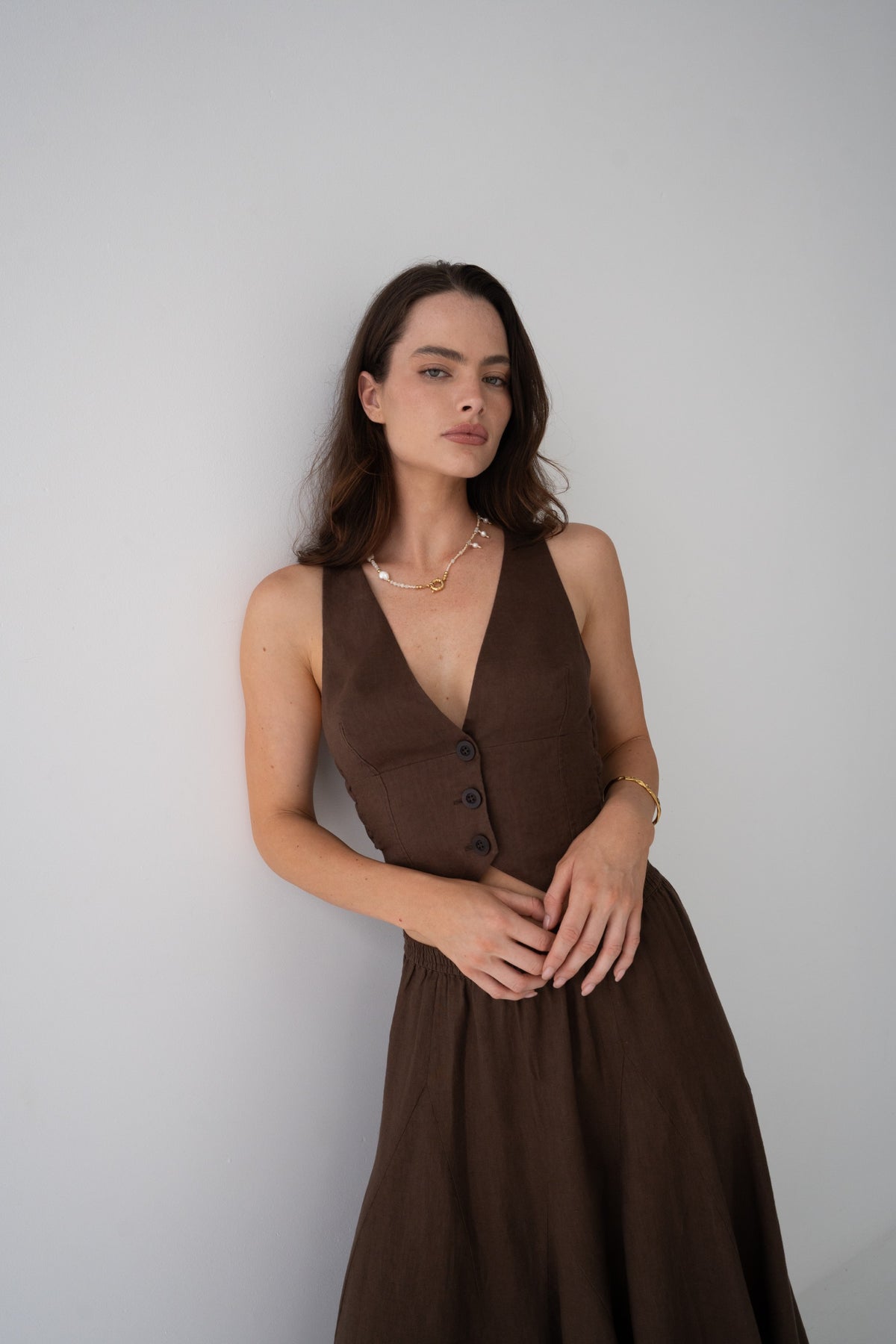 Ari Linen Vest in Chocolate - woman wearing chocolate linen vest and skirt set, full-length front view, studio setting - Lilly Pilly Collection