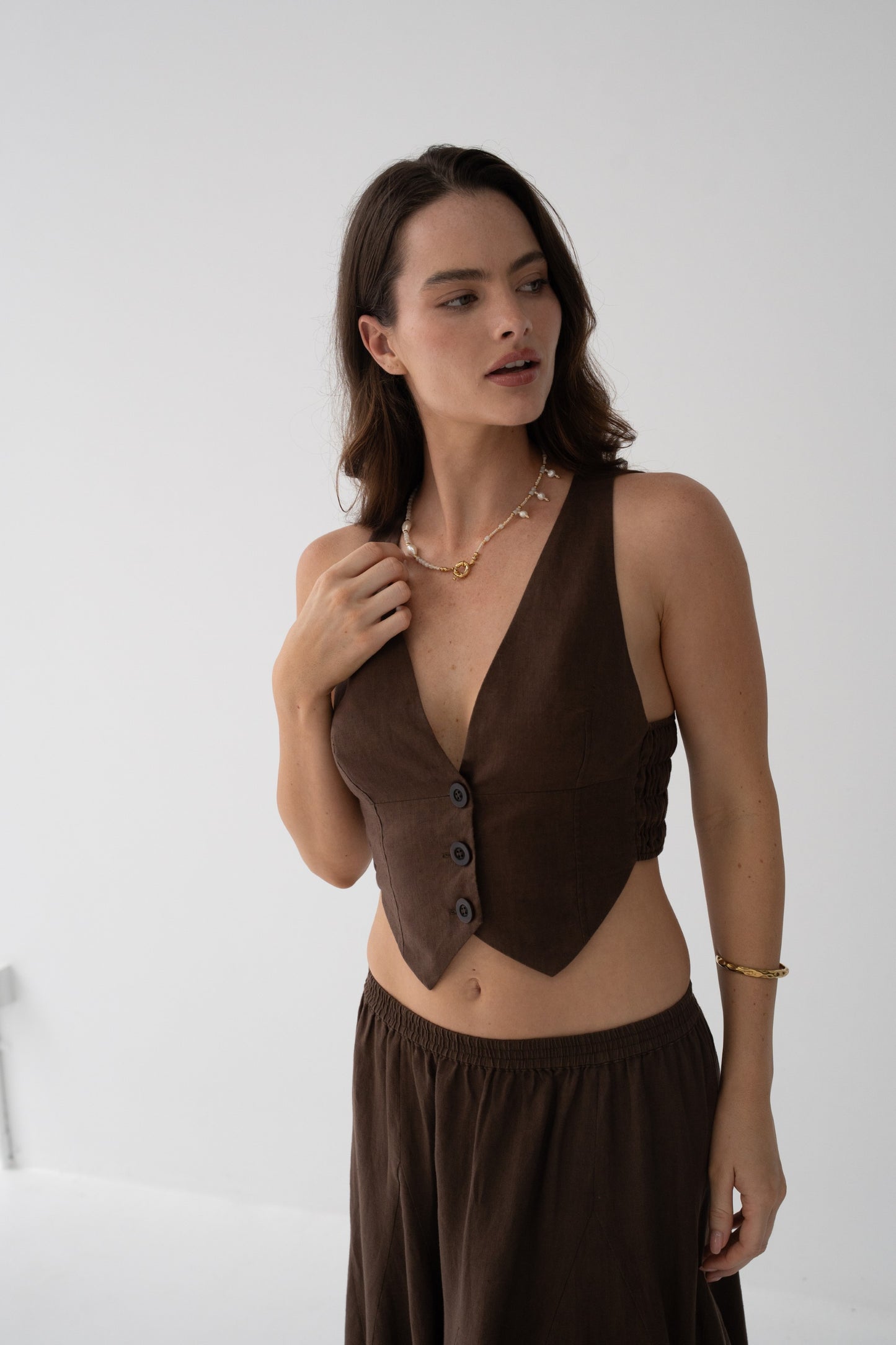 Ari Linen Vest in Chocolate - close-up detail of V-neckline, button-front and ruched side seam in chocolate linen - Lilly Pilly Collection