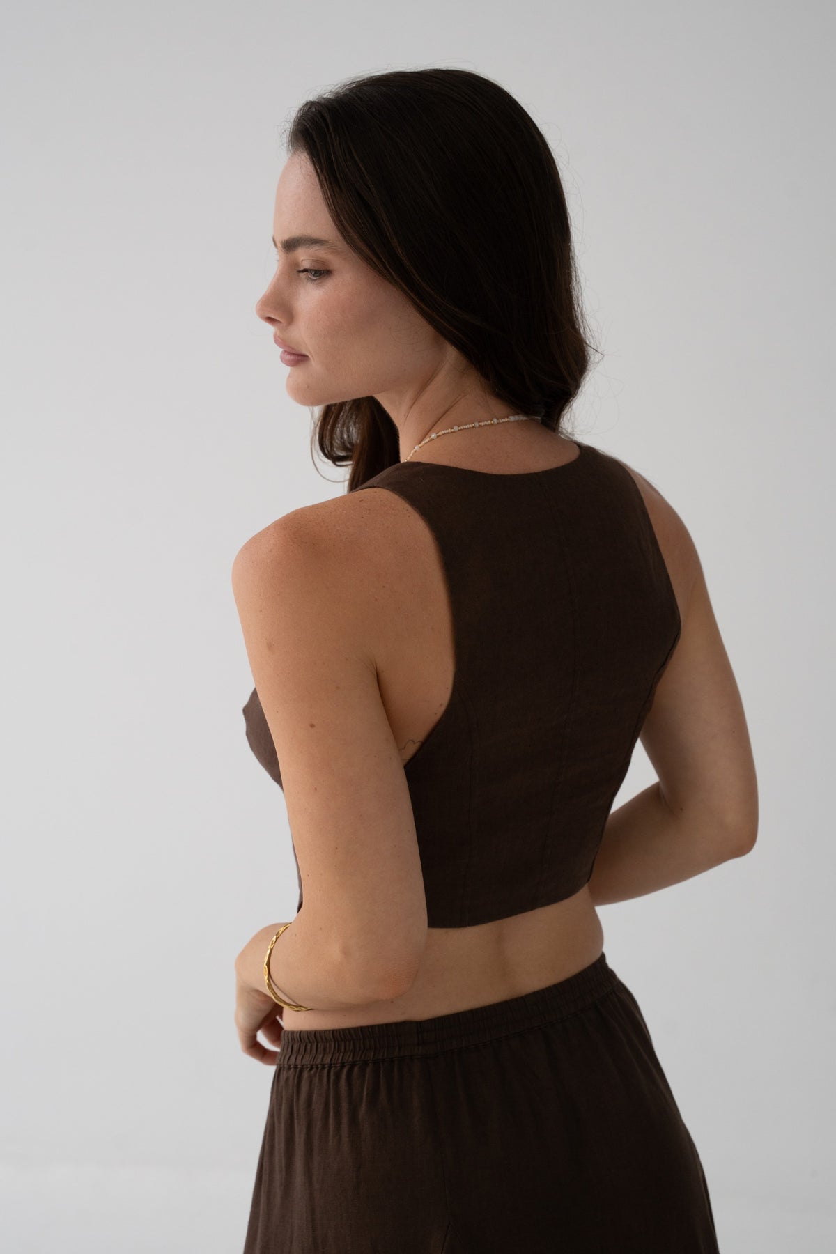 Ari Linen Vest in Chocolate - back view showing clean racerback silhouette and cropped hem, styled with matching chocolate linen skirt - Lilly Pilly Collection