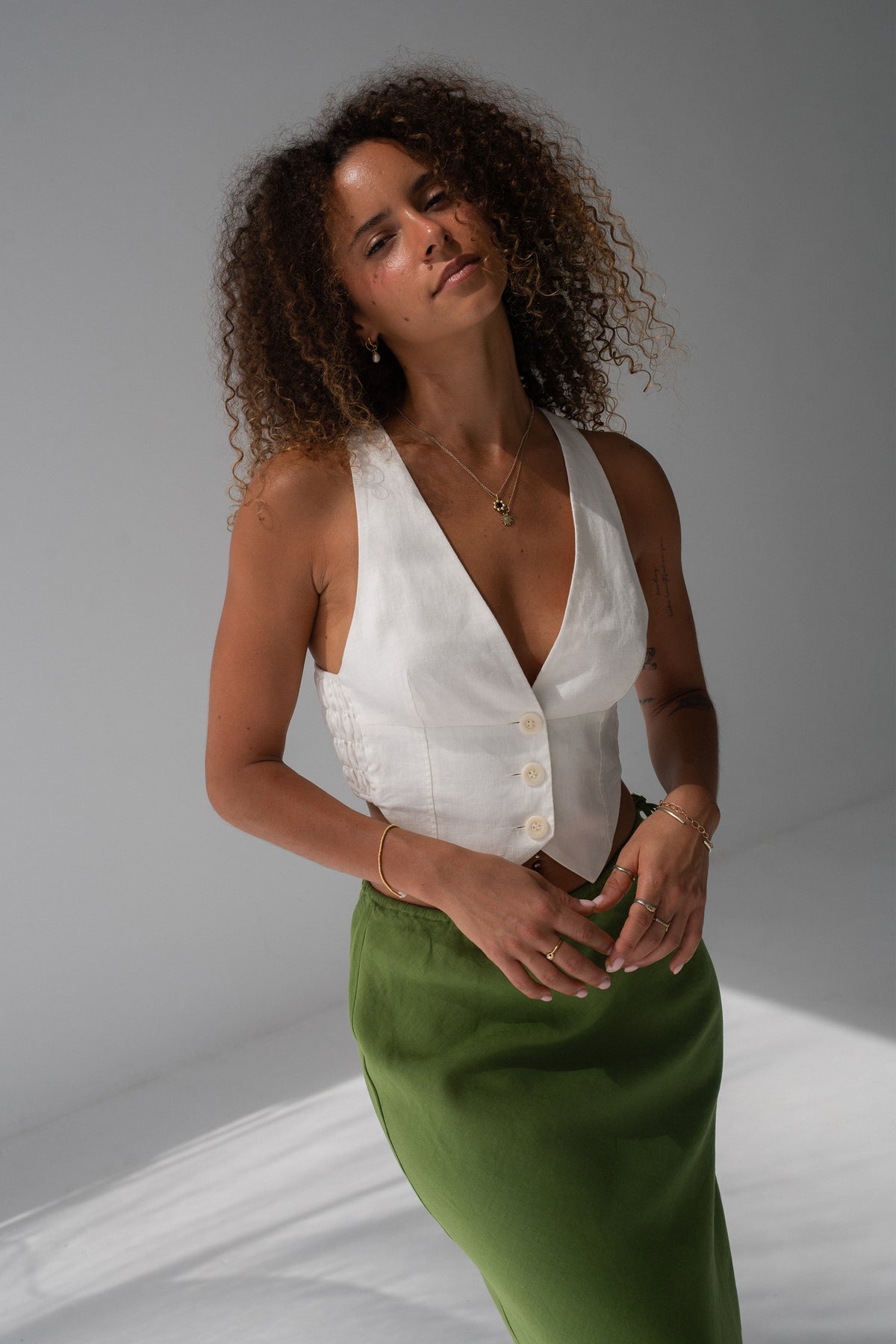 Ari Linen Vest in Ivory - front view, deep V-neckline and button-front, styled with Riley Linen lime green skirt - Lilly Pilly Collection