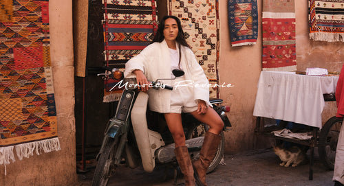 Women wearing Aster Linen puffer jacket in Ivory while sitting on a motorscooter - Lilly Pilly Collection