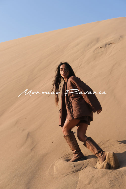 LILLY PILLY woman standing on a sand dune with 'Morocco Reverie' text overlay
