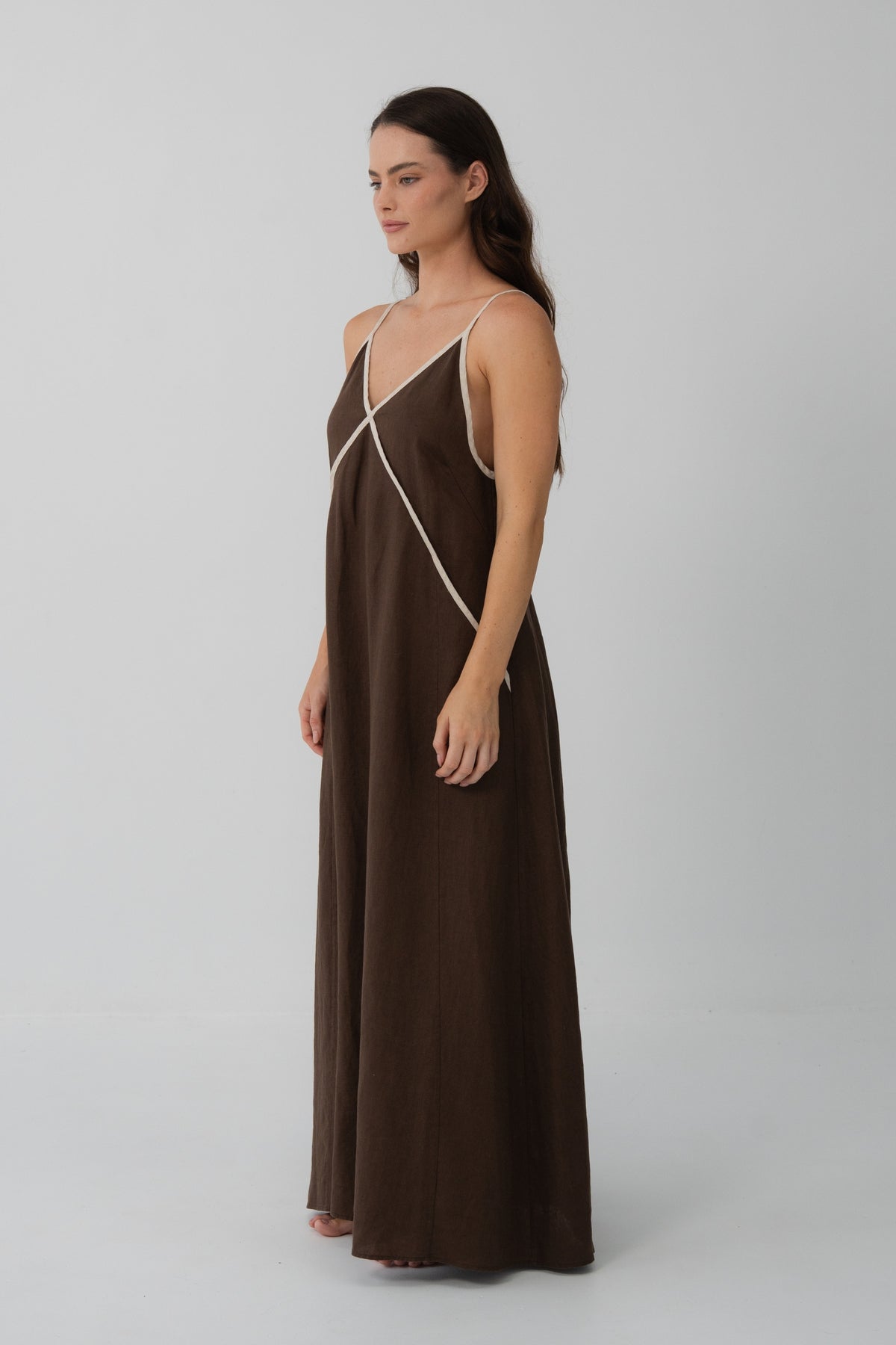 Azalea Linen Maxi Dress in Chocolate - side profile, hand in pocket, relaxed maxi silhouette - Lilly Pilly Collection