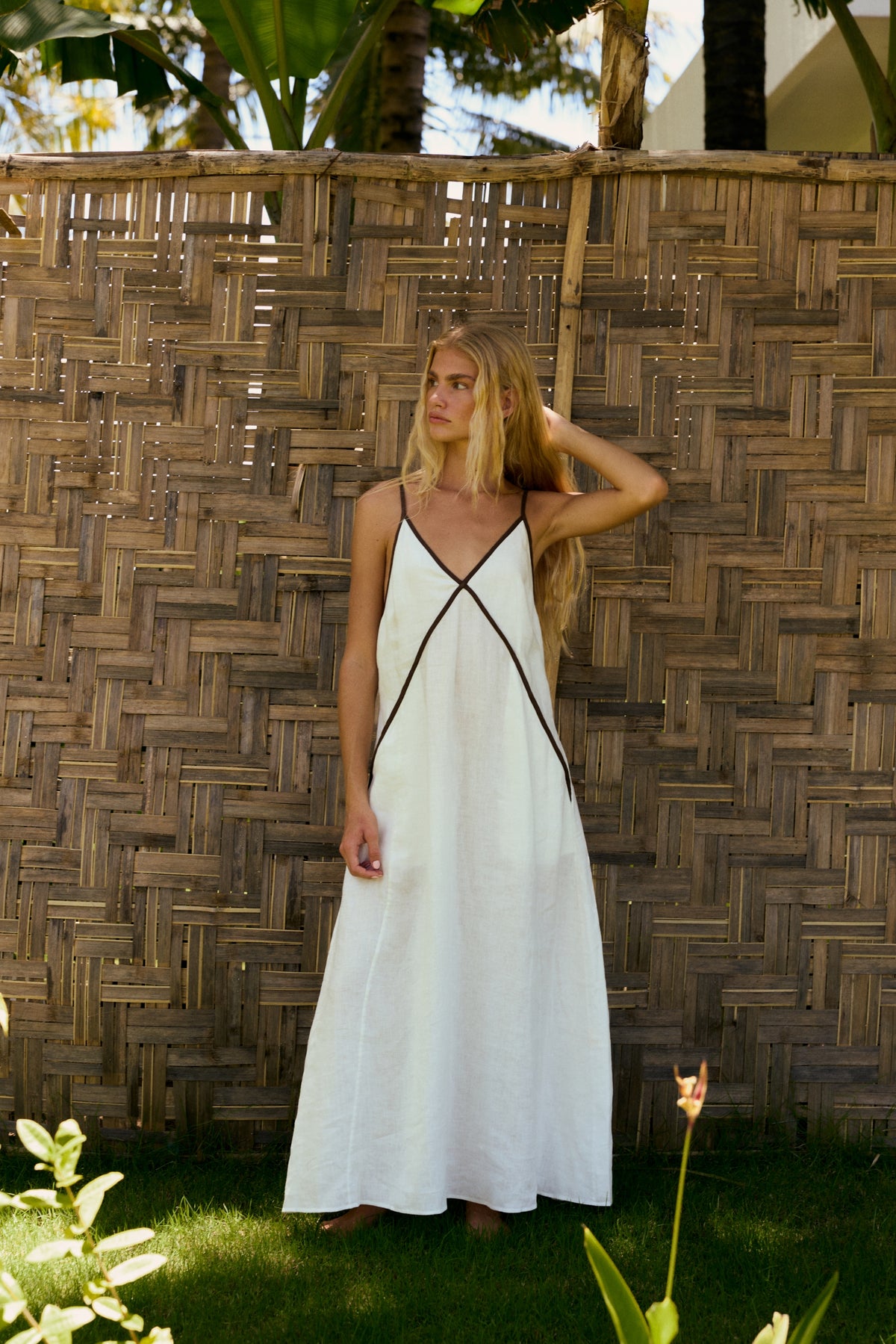 Azalea Linen Maxi Dress in Ivory - full length view, V-neckline with contrast trim and side pockets, outdoor setting - Lilly Pilly Collection