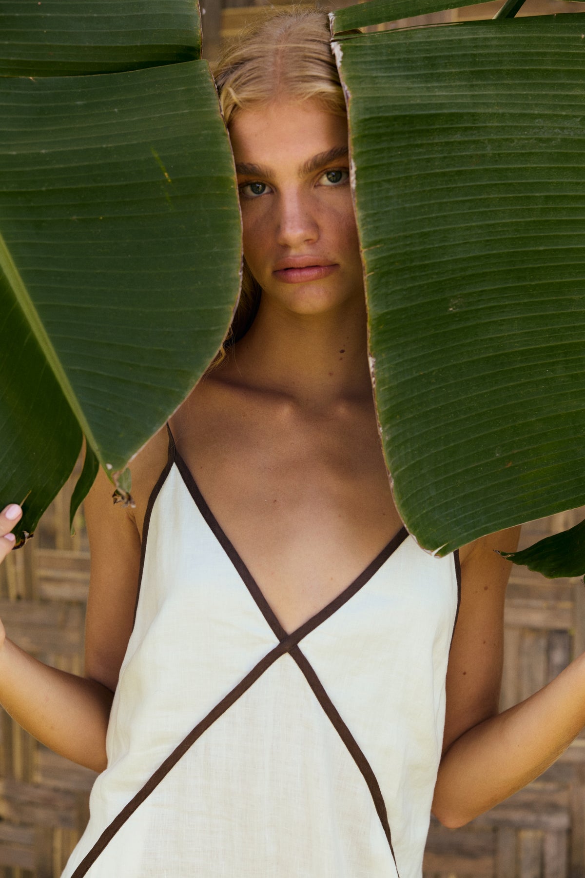 Azalea Linen Maxi Dress in Ivory - woman outdoors, V-neckline and contrast trim detail - Lilly Pilly Collection