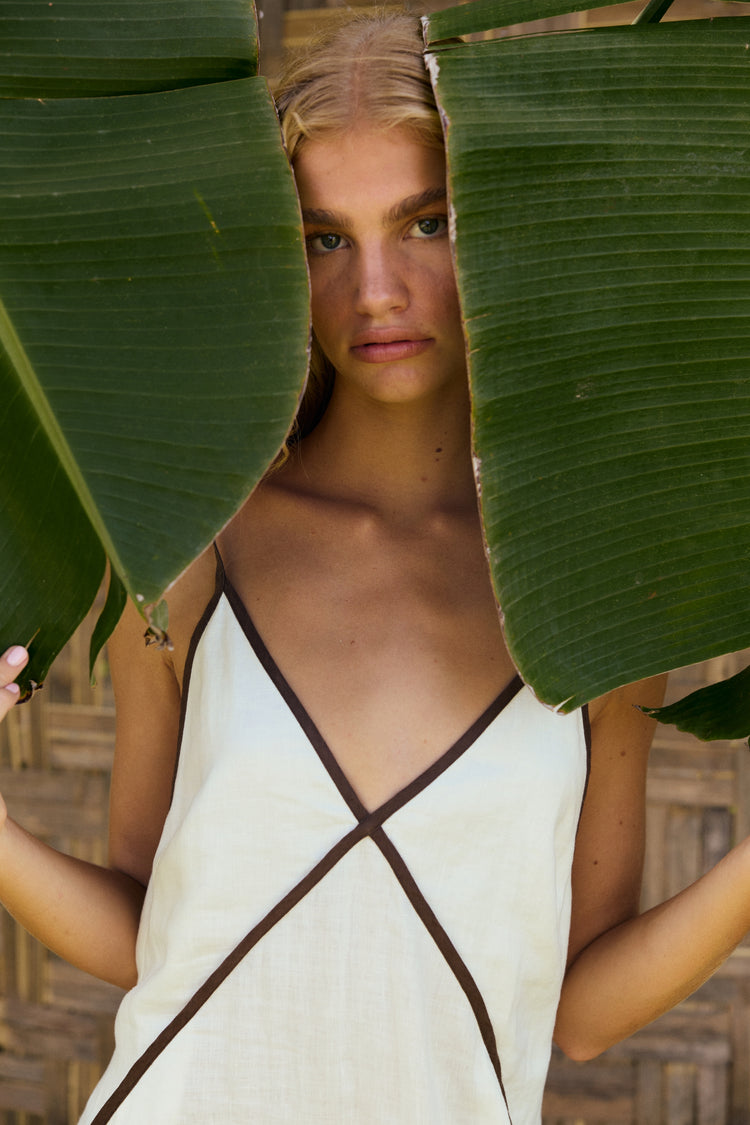 Azalea Linen Maxi Dress in Ivory - woman outdoors, V-neckline and contrast trim detail - Lilly Pilly Collection