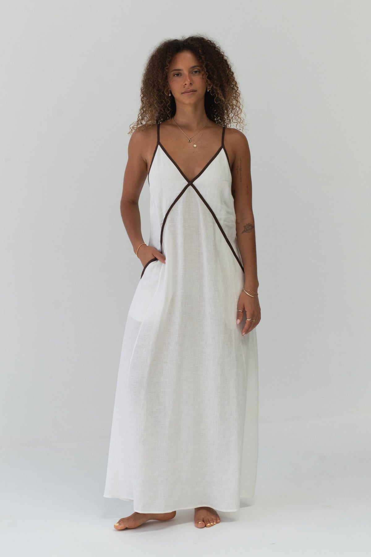 Azalea Linen Maxi Dress in Ivory - full front view, V-neckline with contrast trim, hand in pocket - Lilly Pilly Collection