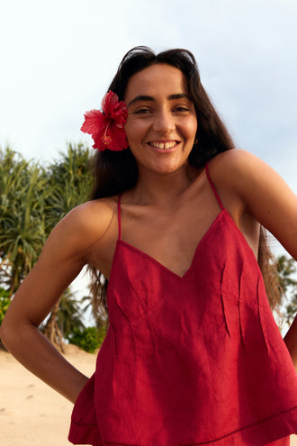 Bea Linen Cami in Cherry Red - full length, walking on beach, styled with matching Riley Linen Maxi Skirt, palm tree and ocean backdrop - Lilly Pilly Collection