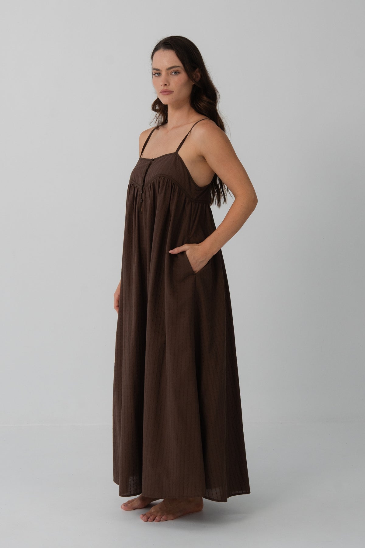 Beatrice Cotton Midi Dress in Chocolate - side profile, hand in pocket, voluminous midi silhouette - Lilly Pilly Collection