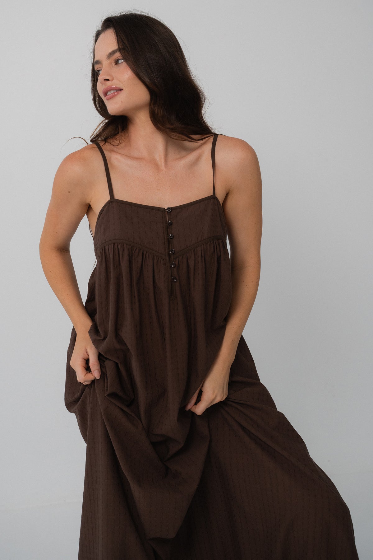 Beatrice Cotton Midi Dress in Chocolate - full front view, spaghetti straps and button-front bodice, hand in pocket - Lilly Pilly Collection