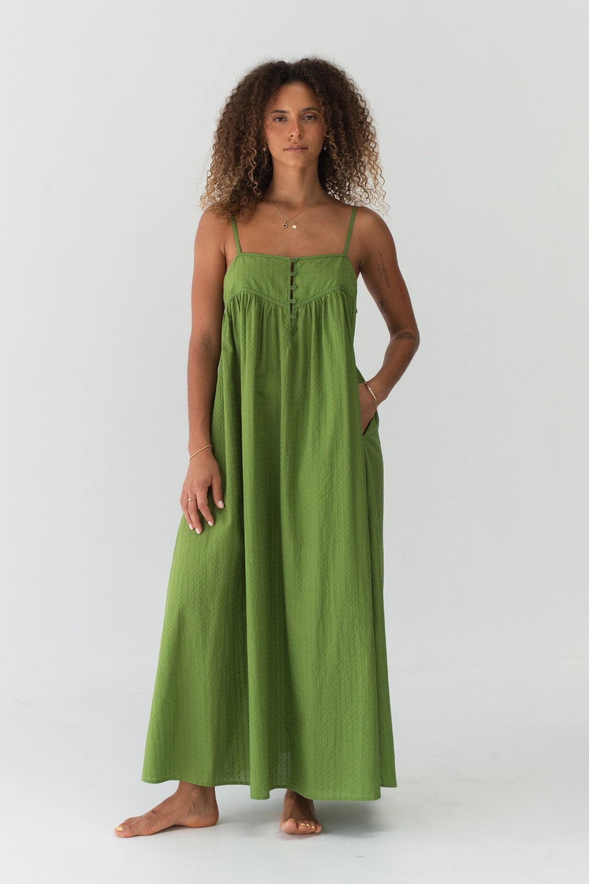 Beatrice Cotton Midi Dress in Lime Green - full front view, spaghetti straps and button-front bodice, hand in pocket - Lilly Pilly Collection