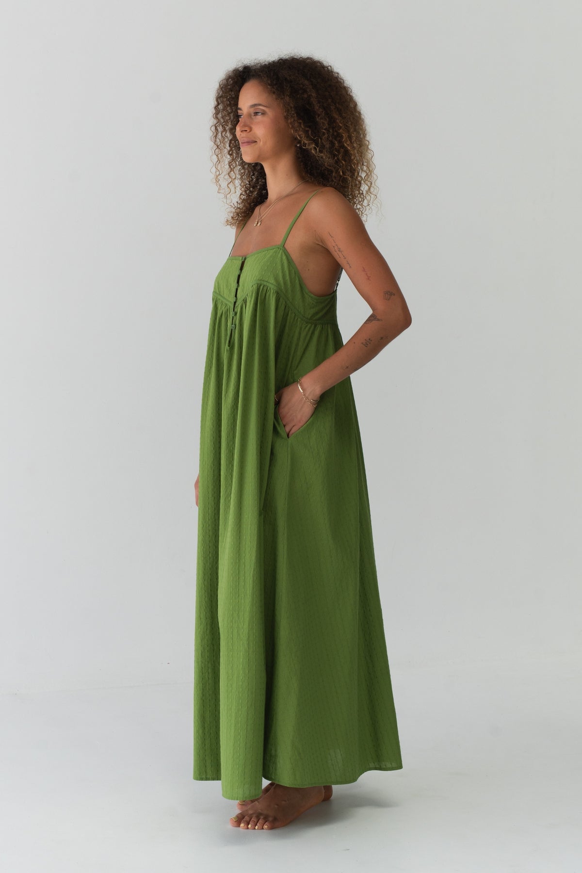 Beatrice Cotton Midi Dress in Lime Green - side profile, hand in pocket, voluminous midi silhouette - Lilly Pilly Collection