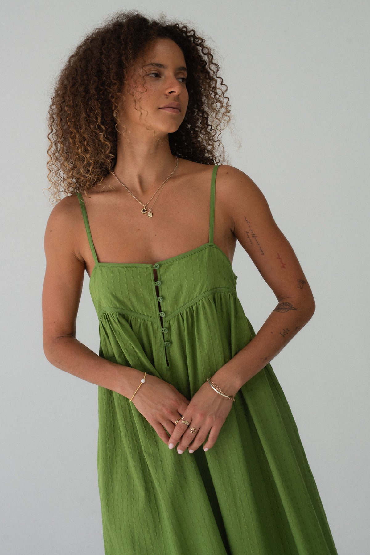 Beatrice Cotton Midi Dress in Lime Green - 3/4 view, spaghetti straps and button-front bodice, hand in pocket - Lilly Pilly Collection

