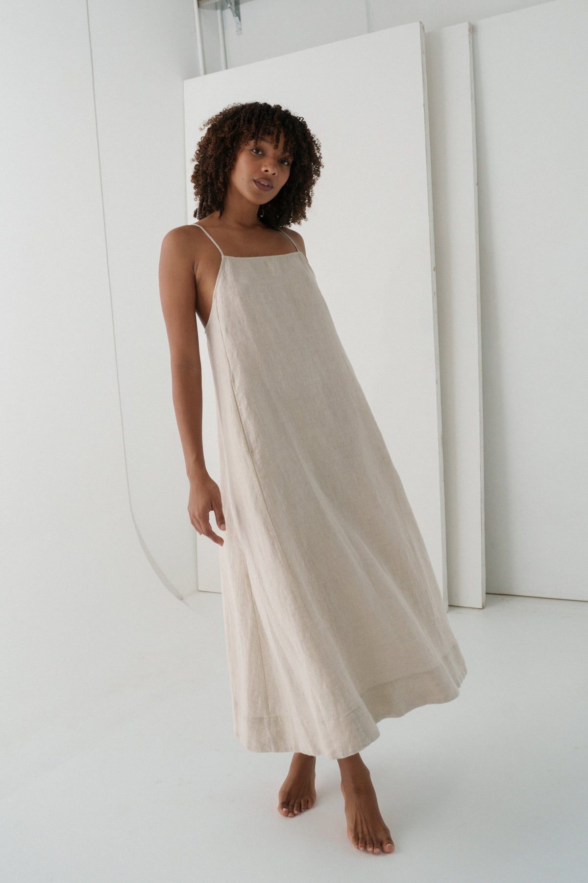LILLY PILLY woman wearing a oatmeal Coco linen dress showing front view with a white background